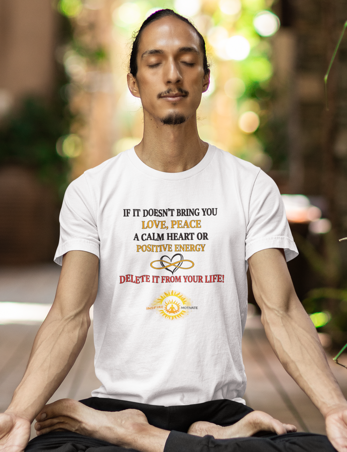 Man meditating on a mat with a motivational quote t-shirt in an outdoor setting