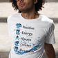 Person sitting on steps wearing a white t-shirt with text design.
