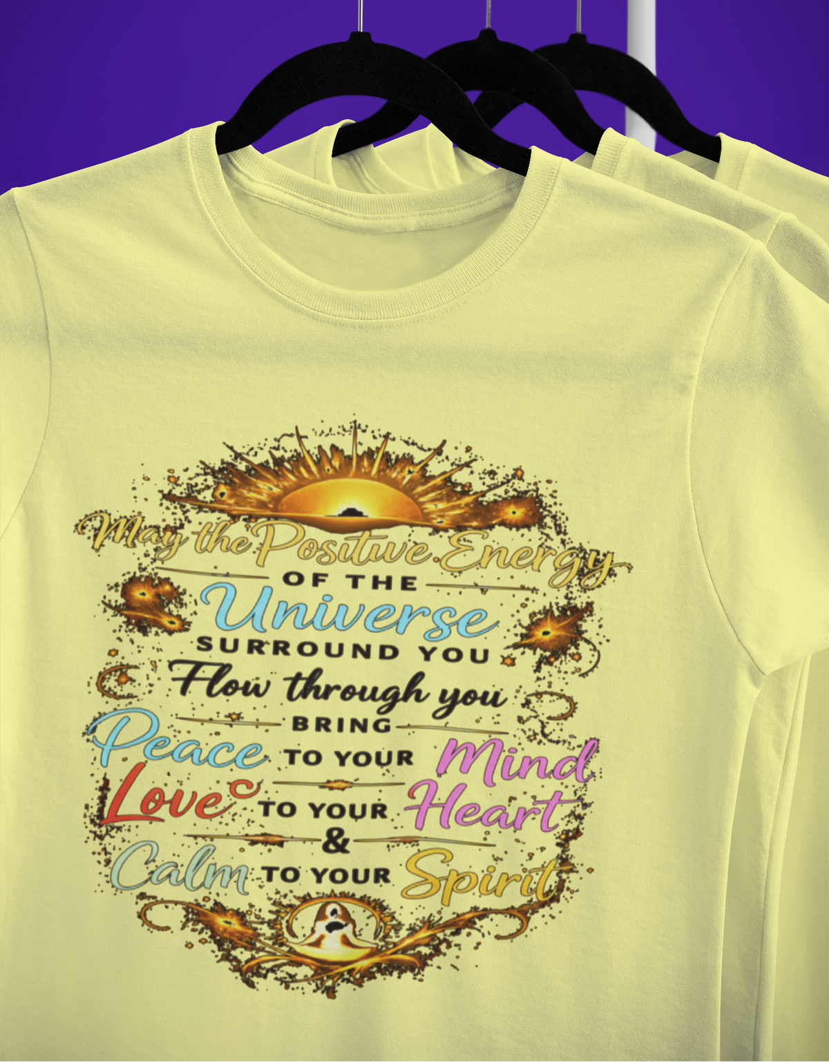 Yellow t-shirt with motivational quote on a hanger against a purple background